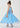 Young girl wearing a blue dress with star pattern on a white background