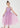 Young girl wearing a pink dress with star patterns on a white background