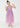 Young girl wearing a purple dress with star patterns on a white background