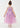 Young girl wearing a pink dress with star patterns on a white background