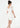 Woman wearing a white dress on a plain background
