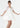 Woman wearing a white dress with sheer sleeves on a white background